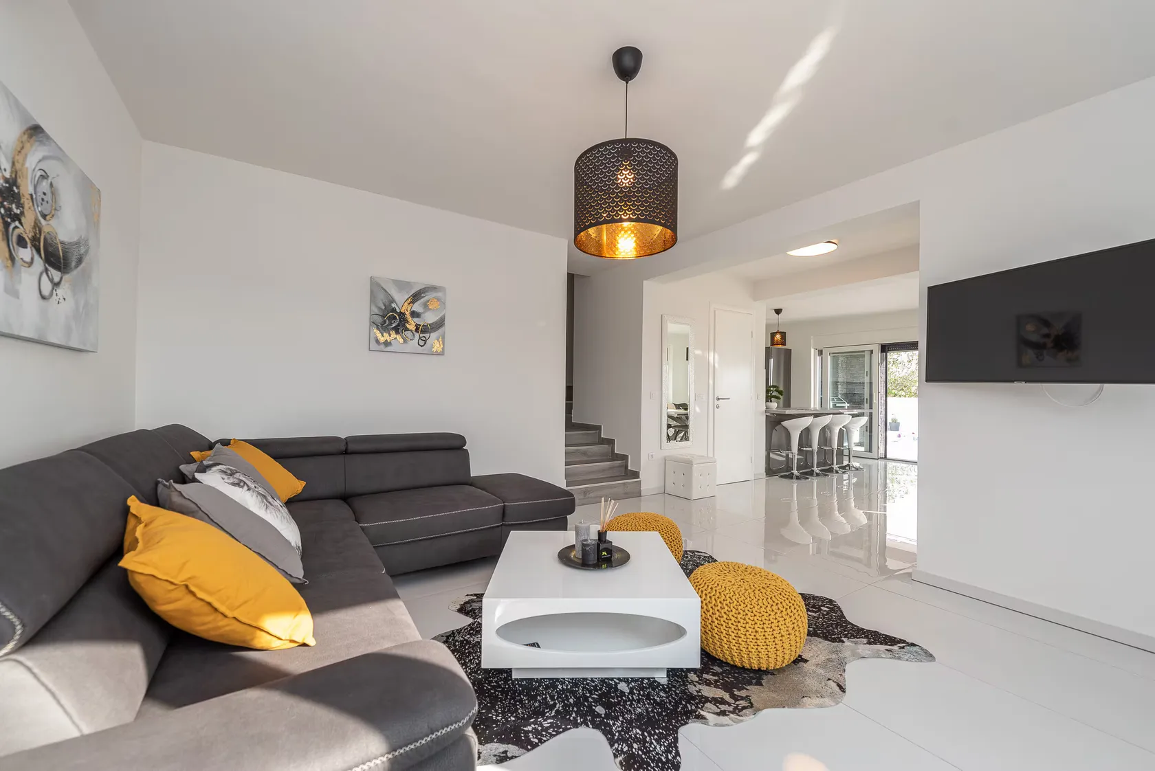 Open living room with warm accents and the staircase